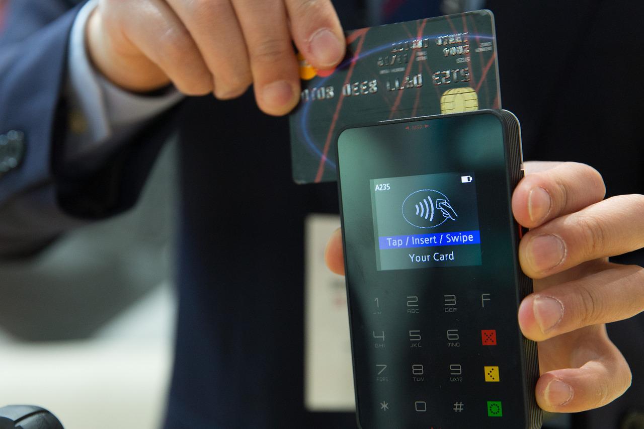 Hand Sliding a Credit Card on Processing Machine